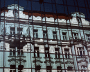 * Old building reflected in new, Prague.